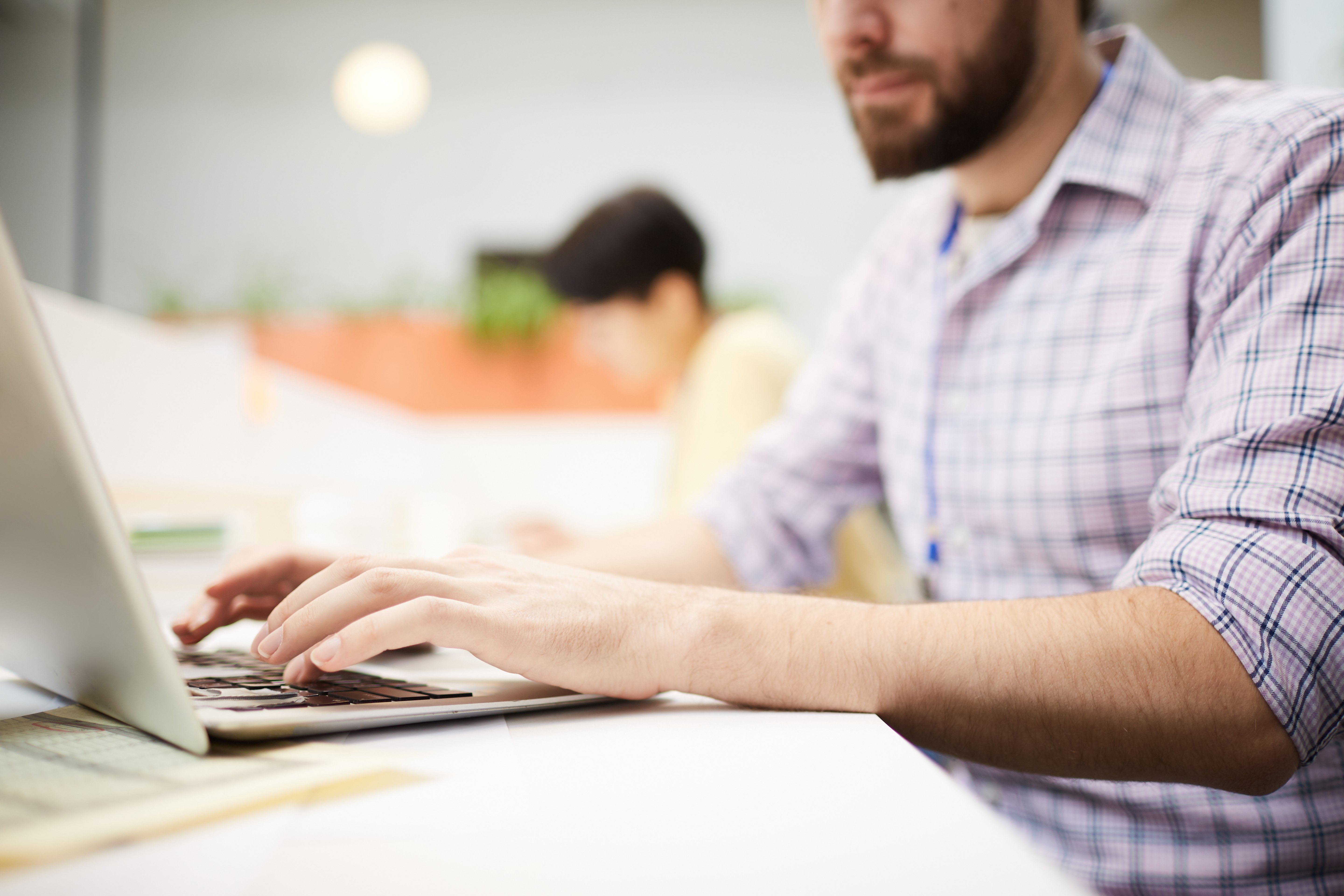 Man typing on laptop